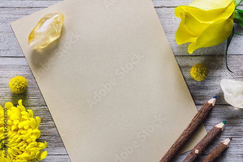 Paper on Rustic Table with Colored Pencils, Citrine and Flowers photo