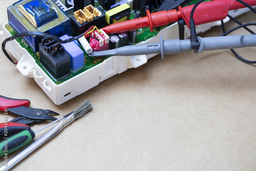 Repair Work Of Electronic Circuit Bord With Oscilloscope Probe Connect To Device For Measuring The Signal. Repair Work Of Electronic Circuit Bord With Oscilloscope Probe Connect To Device For Measuring The Signal.