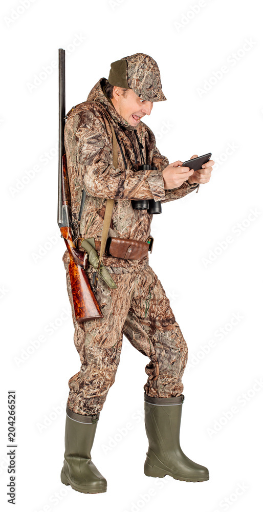 Obraz premium Full length portrait of a male hunter with double barreled shotgun Isolated on white background. hunting and people concept