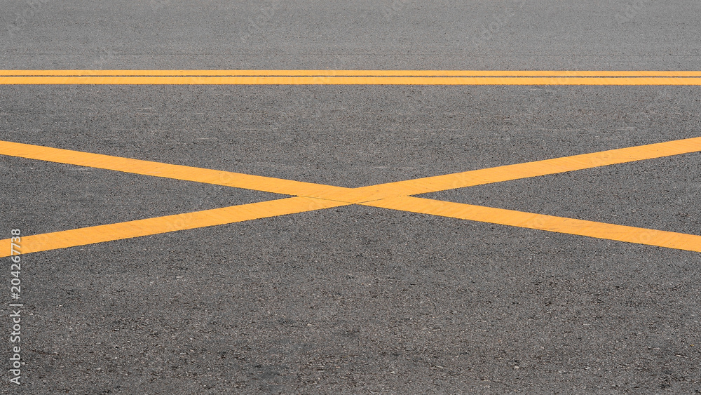 abstract yellow painted line on asphalt road background Stock Photo