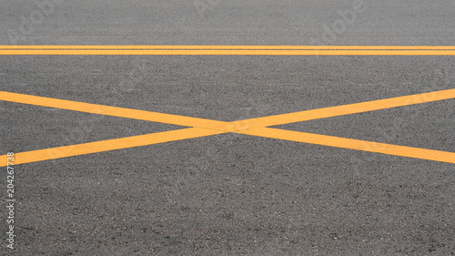 abstract yellow painted line on asphalt road - background