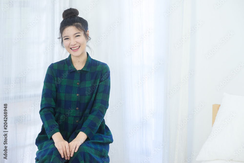 Close up of charming beautiful perfect skin Asian woman sitting in bedroom and look at camera Close up of charming beautiful perfect skin Asian woman sitting in bedroom and look at camera