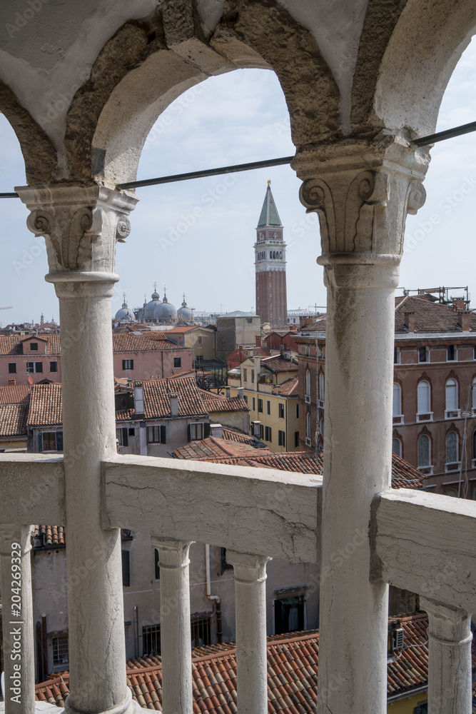 Panorama of Venice seen through the arches of an ancient palace.