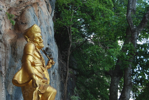 Golden holy statue on the way up to hill by Tiger Cave, Krabi, Thailand
