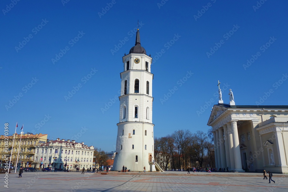 View to Vilnius city street -Gedimino avenue, Vilnius Cathedral and bell tower with people walking during sunny day, Lithuania