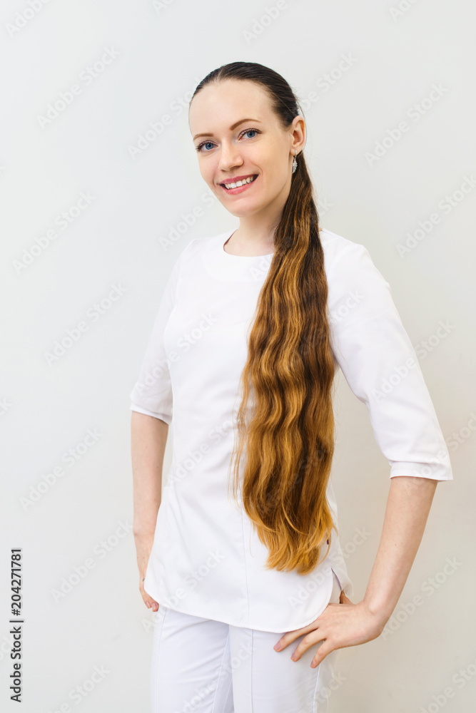 Smiling female doctor in white coat over white isolated background with crossed arms, healthcare, profession and medicine concept Smiling female doctor in white coat over white isolated background with crossed arms, healthcare, profession and medicine concept