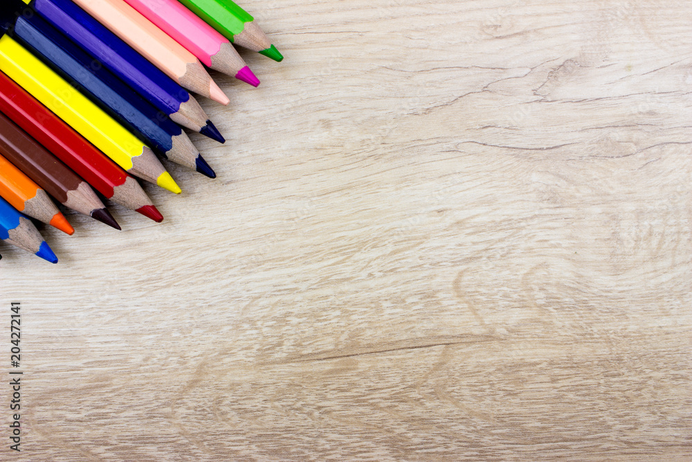 Pencils set on wooden table. Empty space for text and design. Minimalism concept Pencils set on wooden table. Empty space for text and design. Minimalism concept
