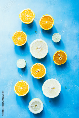 Summer fruit background, top view of summer fruit Assortment of citrus fruits on a blue background, top view,avocado,Oranges, grapefruit, tangerine, lime, lemon ,vegetarian healthy food concept.
