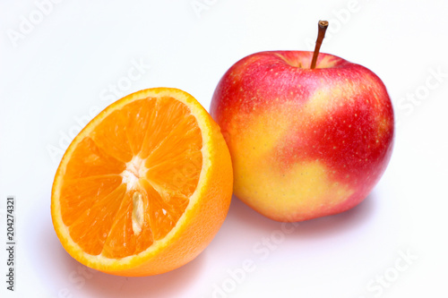 red apple and orange on a white background