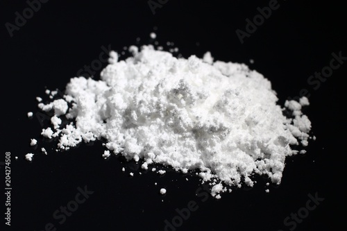 Creatine monohydrate on a dark background photo