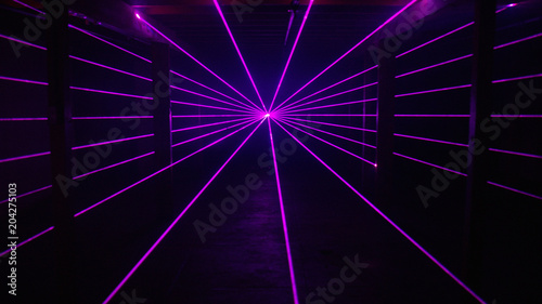 Thin purple laser beams shine past columns background