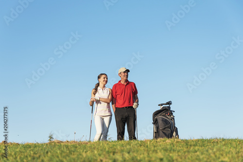 Golfer and Caddie playing golf.