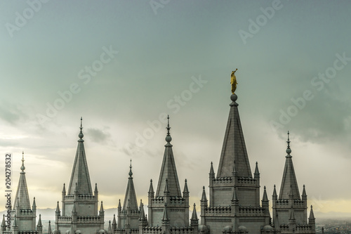 The Angel Moroni and spires of Salt Lake Temple on an overcast spring evening. The Church of Jesus Christ of Latter-day Saints, Temple Square, Salt Lake City, Utah, USA. photo