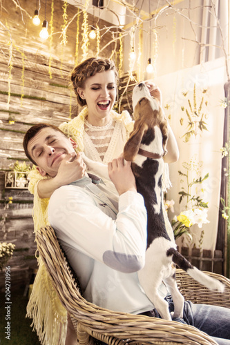 portrait of happy couple with pet in the living room