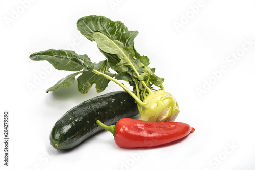 Various vegetables are isolated on a white surface