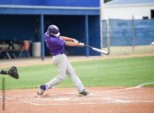 Photography Baseball players in action on the baseball field - throwing and swinging the bat