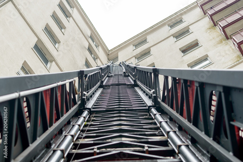 Looking up a Fireman Ladder, Firefighter Truck extendable Ladder next to Tower Block, England 2018 shallow depth of field horizontal perspective photography