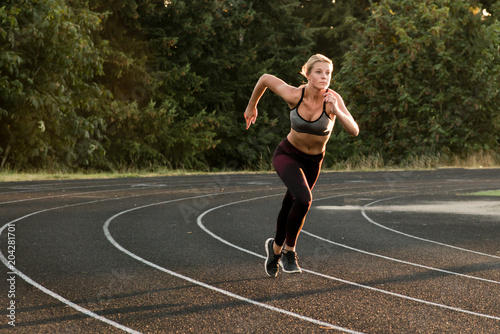 Athletic woman running on track © presidentk52
