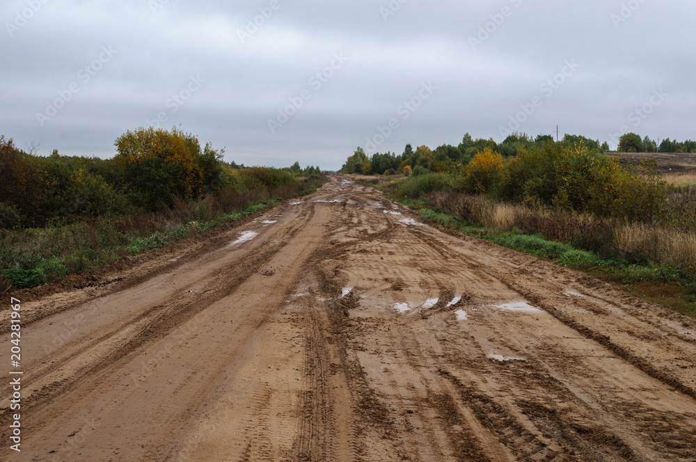 Fototapeta premium Sandy road with puddles