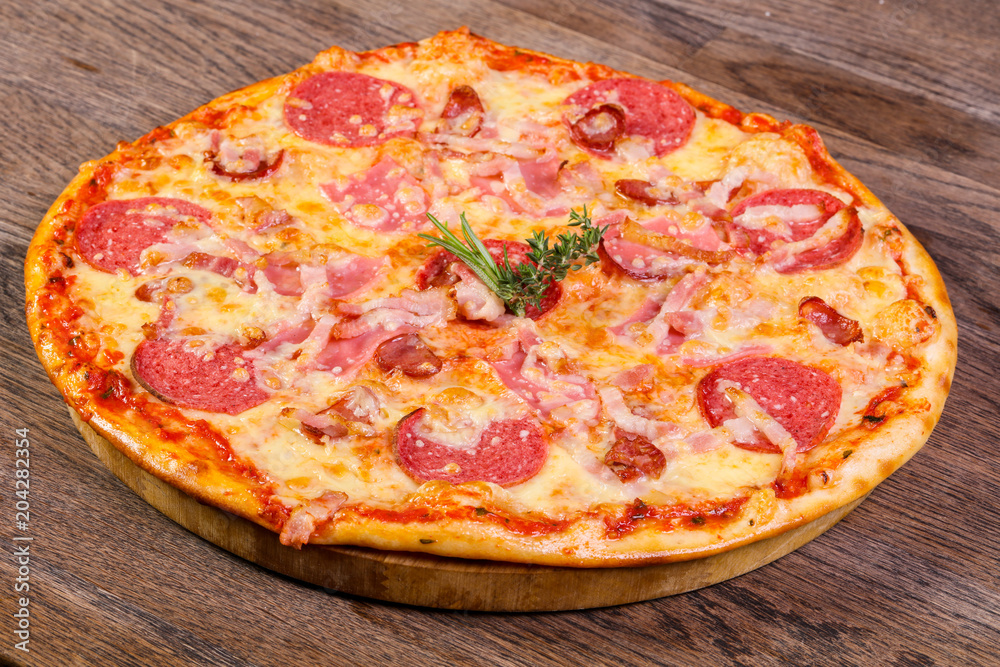 Pizza with ham and sausages