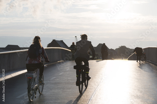 COPENHAGEN, DENMARK - SEPTEMBER 22 2017: Cyclists on bridge inderhavnsbroen on a sunny morning photo