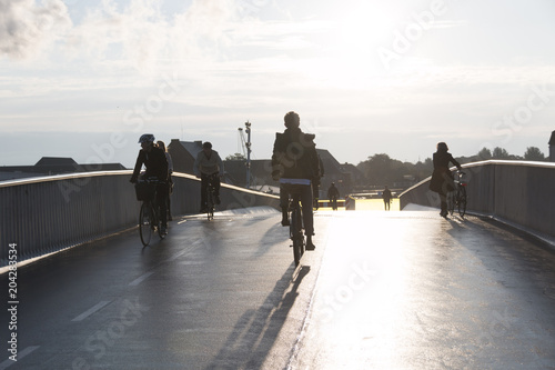 COPENHAGEN, DENMARK - SEPTEMBER 22 2017: Cyclists on bridge inderhavnsbroen on a sunny morning photo