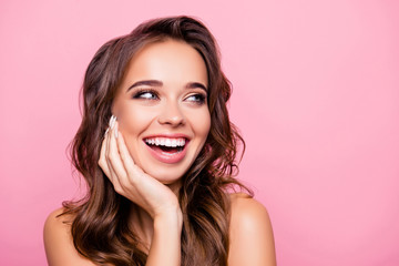 Aging, acne, pimples, wrinkles, oily, dry skin concept - close up portrait of pretty excited lady with wavy hairdo, holding palms on cheek, isolated on pink background