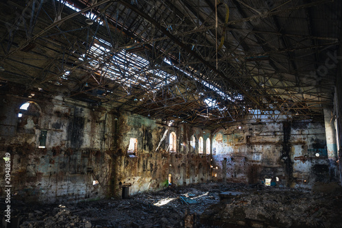 Ruined and abandoned dark creepy factory house building inside  industrial warehouse hall waiting for demolition