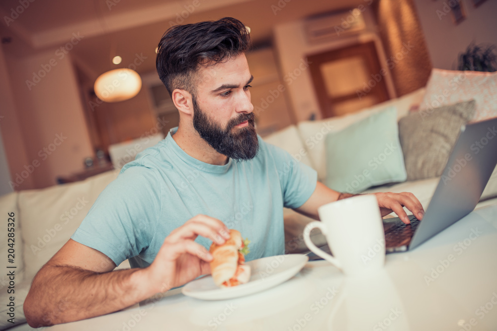 Man working on laptop from home Man working on laptop from home