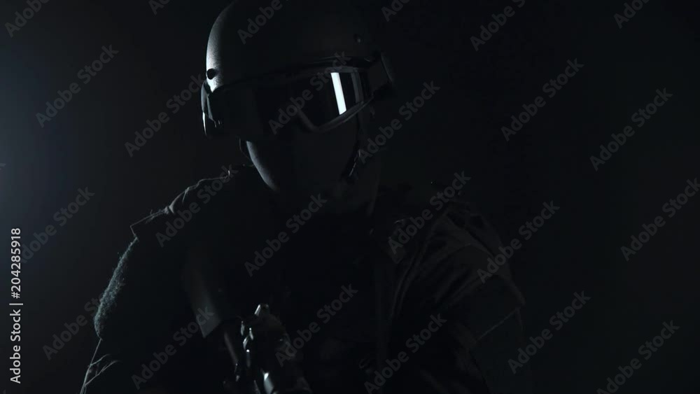 Spec ops police officer SWAT in black uniform studio Spec ops police officer SWAT in black uniform studio