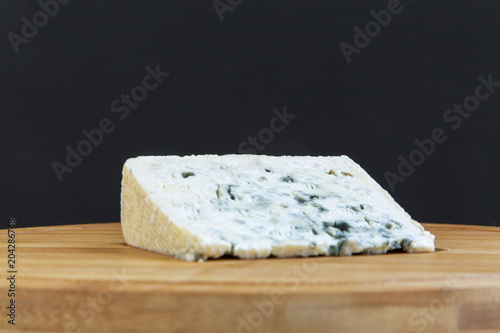 Blue cheese on wooden board. Closeup.