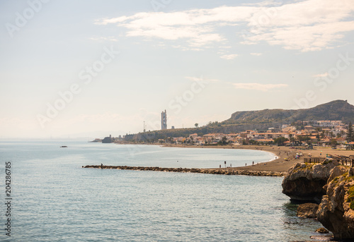 high cliff above the sea, summer sea background, many splashing waves and stone