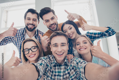 Self portrait of economists, students, financiers, lawyers in casual outfit showing thumb up with fingers shooting selfie on front camera with joyful cheerful expression having leisure, timeout