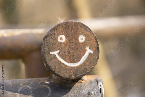 Smiling face on round metal construction
