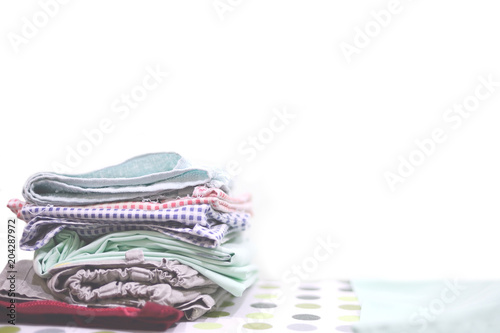 Pile of clothes on white background. Selective and soft focus.