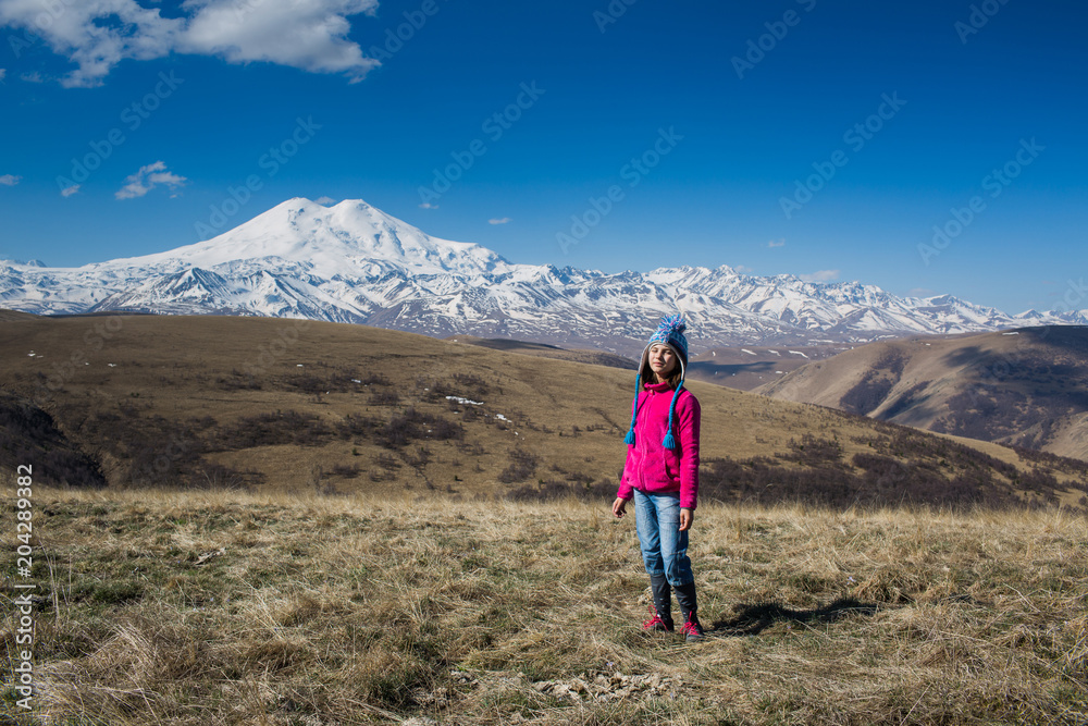 portrait of a girl in full growth on the background of a snow peak