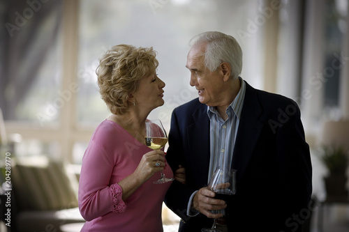 elderly couple drinking wine photo