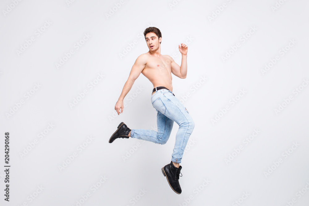 Freedom athlete turn boots shoes vogue modern model advertising concept. Full-length full-size portrait of attractive powerful handsome guy jumping up isolated on gray background copy-space Freedom athlete turn boots shoes vogue modern model advertising concept. Full-length full-size portrait of attractive powerful handsome guy jumping up isolated on gray background copy-space