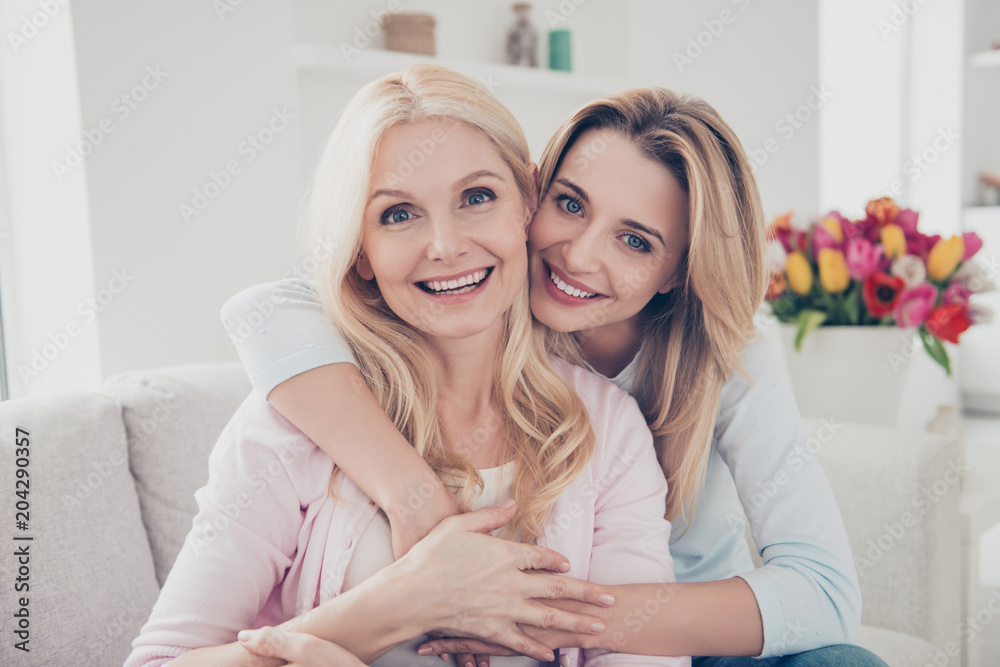 Portrait of pretty charming cheerful trendy positive mother and daughter sitting on couch in living room enjoying time together daydream looking at camera trust understanding support concept Portrait of pretty charming cheerful trendy positive mother and daughter sitting on couch in living room enjoying time together daydream looking at camera trust understanding support concept