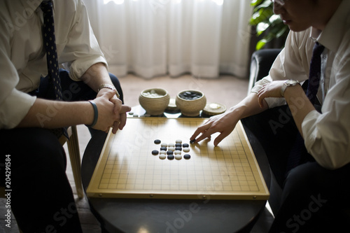 Board game being played by two businessmen.