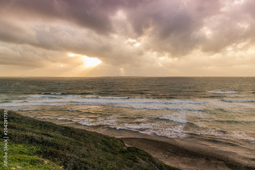 Sun hides behind the cloud on the sardinian coast Sun hides behind the cloud on the sardinian coast