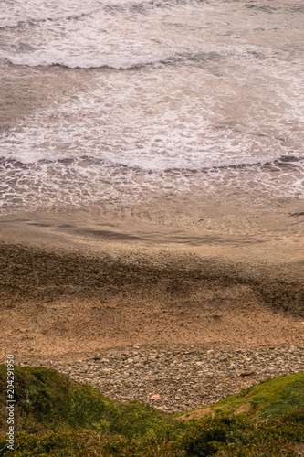 Aerial View on the beach with waves and sand drawing lines