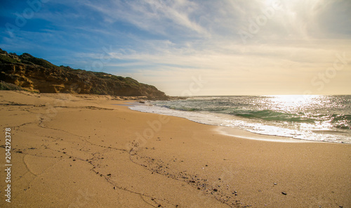 Sun flare on a view with waves and beach