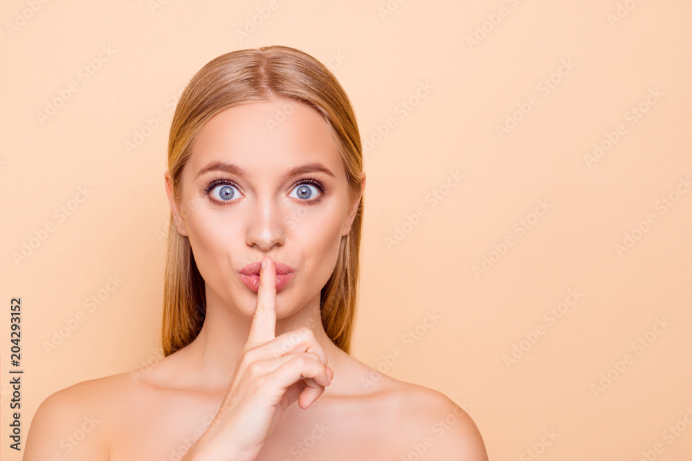 Shhh! Pretty, charming, big-eyed, funny nude natural girl holding forefinger on pout lips showing silence sign isolated on beige background with copy space empty place, advertisement concept Shhh! Pretty, charming, big-eyed, funny nude natural girl holding forefinger on pout lips showing silence sign isolated on beige background with copy space empty place, advertisement concept