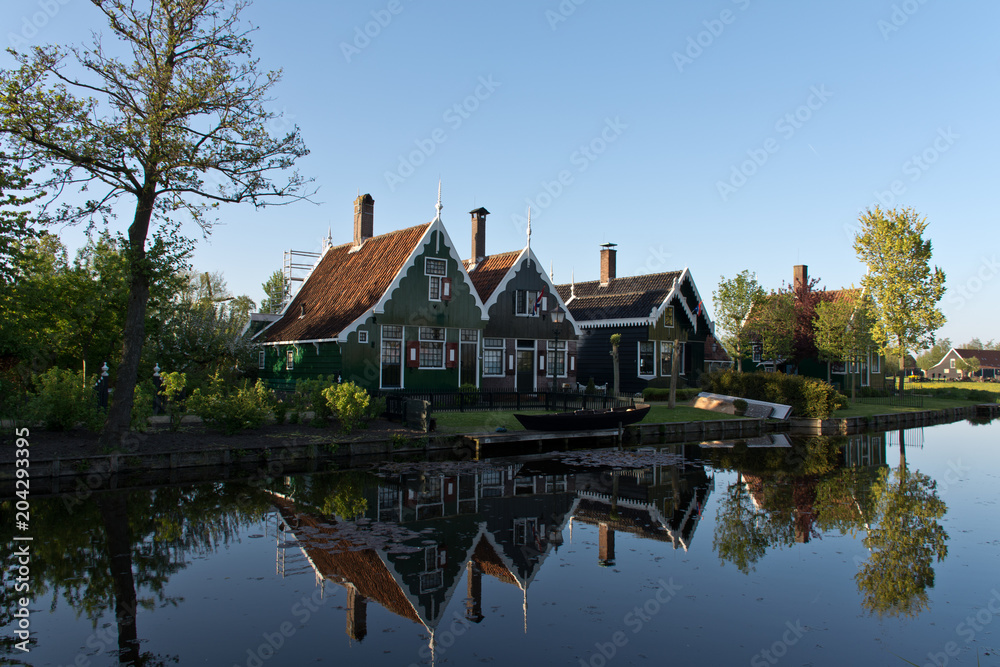 Houses along a canal in Zaanse Schans during sunrise, The Netherlands