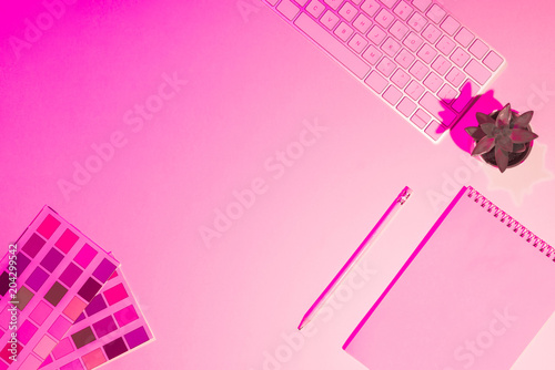 фотографія pink toned picture of paints, empty textbook, pencil, plant and computer keyboar