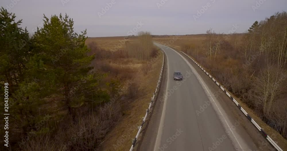 The car goes on the road in the field The car goes on the road in the field