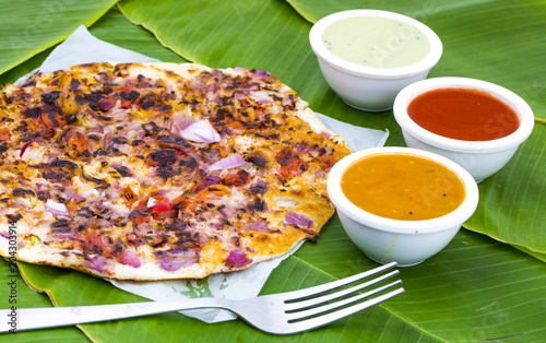 South Indian Food Uttapam Also Know As ooththappam, Rava Uttapam, Uttapa or Uthappa is a Popular South Indian Delicious Spicy Breakfast Snack Served with Coconut Chutney, Tomato Sauce and Sambar photo