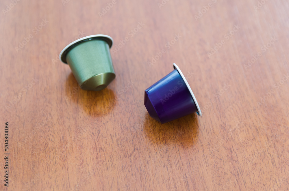 Colored espresso coffee capsules, machine coffee, on wooden background. Colored espresso coffee capsules, machine coffee, on wooden background.