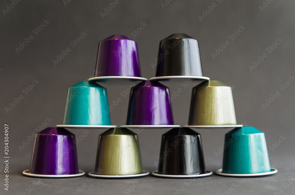 Beautiful colored coffee capsules on black background Beautiful colored coffee capsules on black background
